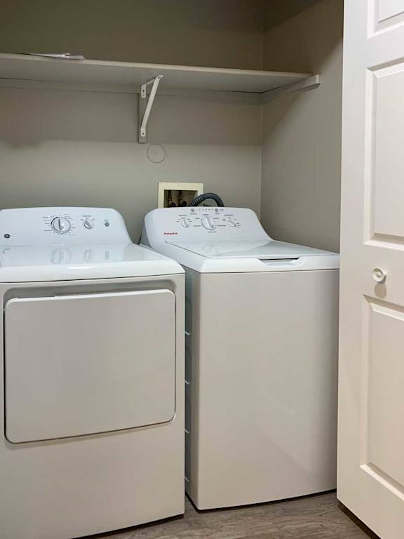a front-loading side-by-side washer and dryer with overhead storage