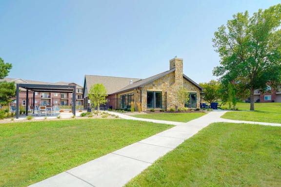 Spacious outdoor area with clubhouse and shaded seating