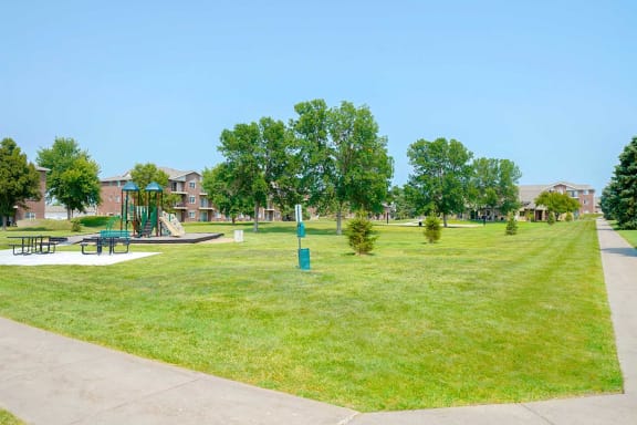 Green lawn and a scenic view of trees and apartments