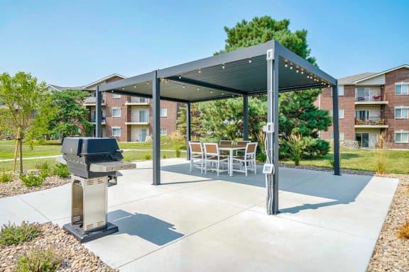 Covered patio with tables and seating near the pool