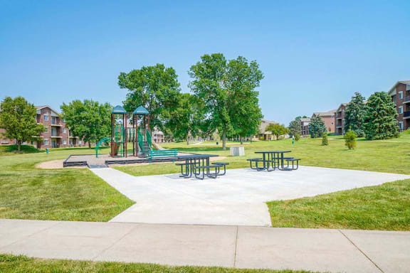 Children's playground with a climbing structure next to a picnic area