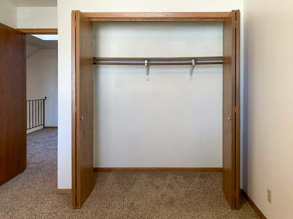 a closet with built-in shelf and hanging space