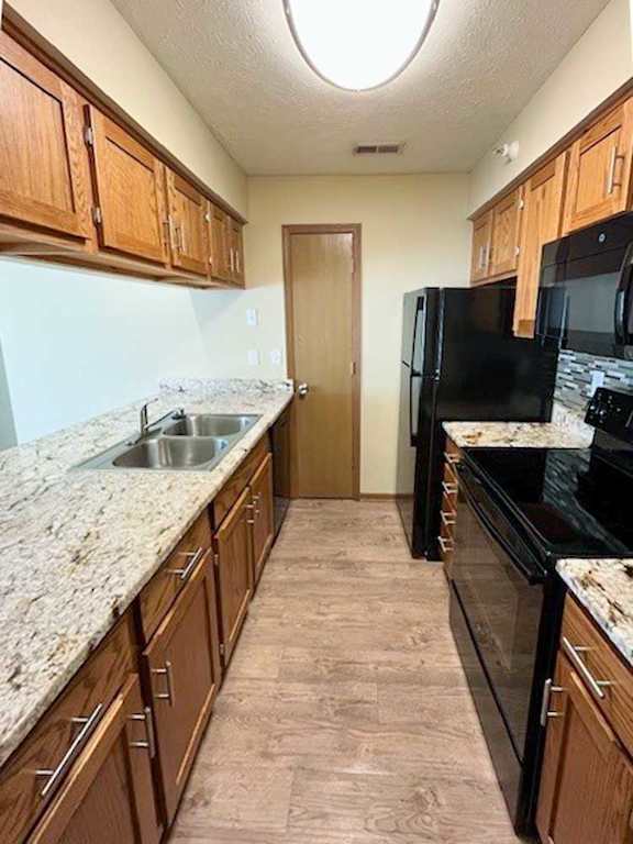a kitchen with black appliances and wooden cabinets