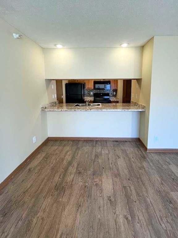 a kitchen with a windowed bar countertop facing the living room