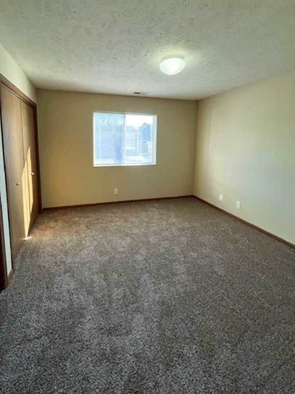 a bedroom with a carpeted floor and a window