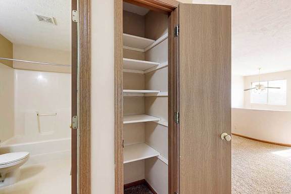 A linen closet in the loft are with built in shelves.