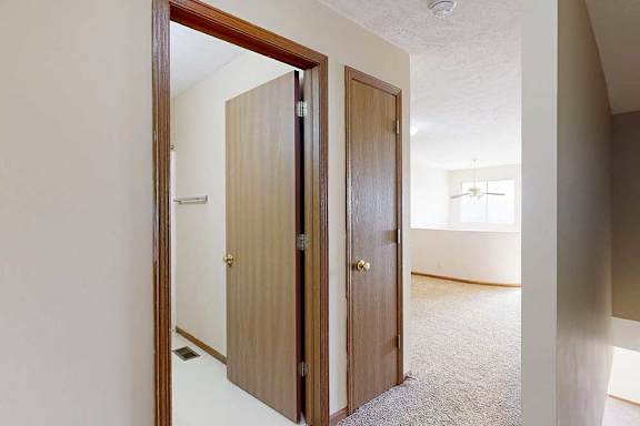 A view from the top of the stairs of the loft bathroom and linen closet.