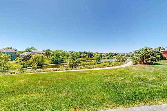 A view from the patio area of the surrounding green space and neighboring pond.