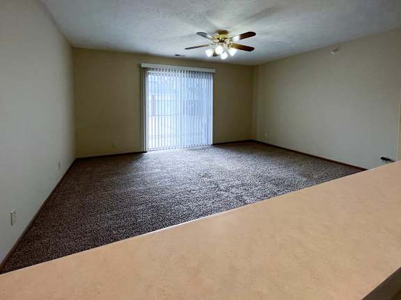 a view of the living room and sleeping area from the kitchen bar top countertop