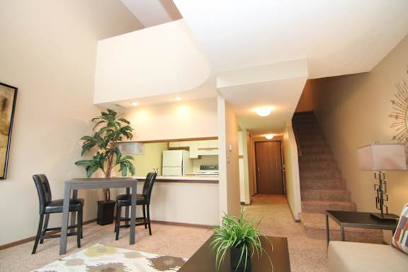 A living room with a dining table and chairs.
