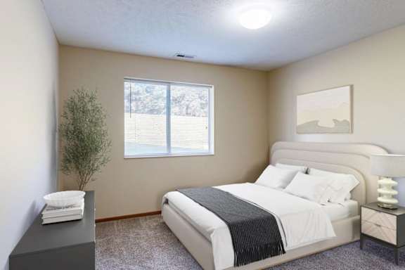 A bedroom with a large bed and a lamp on the nightstand.