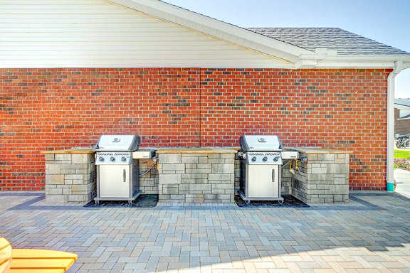 Two outdoor grilling stations with stone counters, perfect for grilling up your favorite recipes.