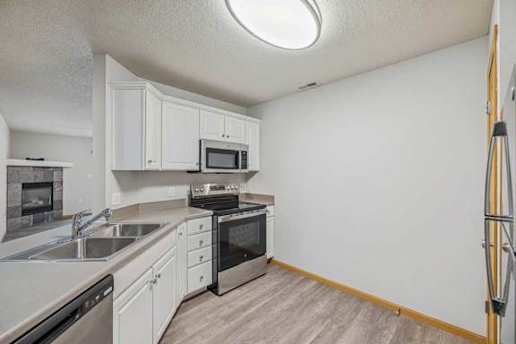 A kitchen with white cabinets and a black oven.