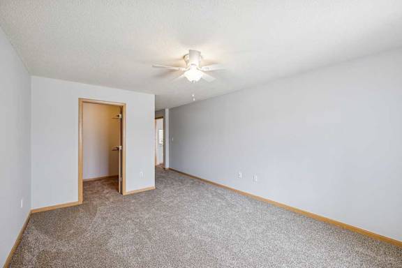 A room with a carpeted floor and a ceiling light.