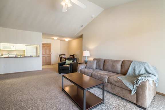 A living room with a couch, chair, and coffee table.