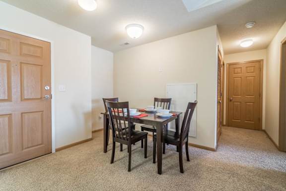 A dining room with a table set for two.