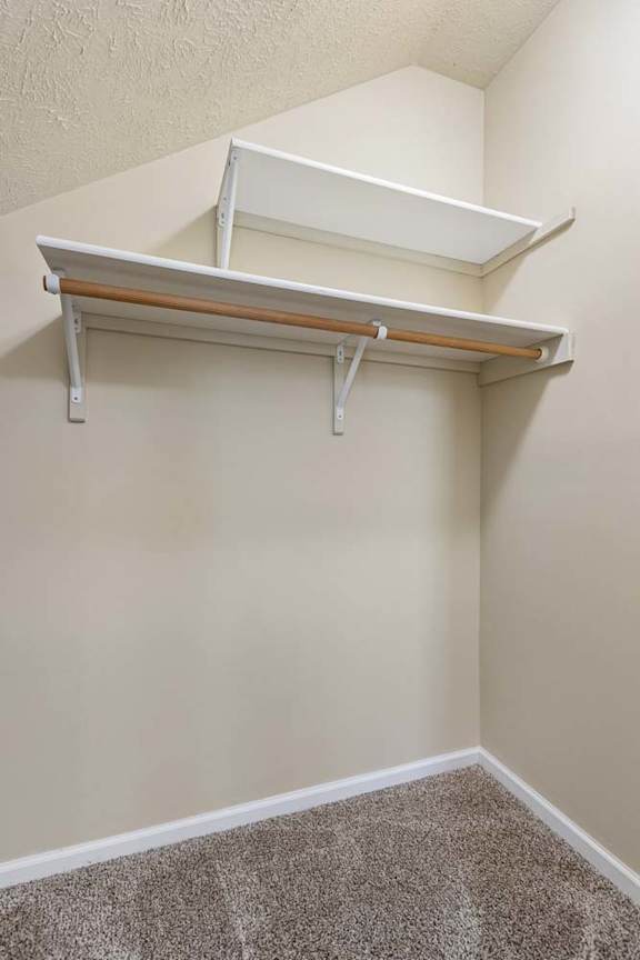 A white shelf is mounted on a wall.