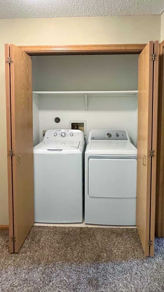 a laundry closet with a washer and dryer in it
