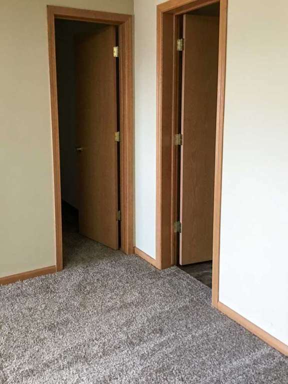 two doors in the loft area, one to the bathroom and the other to the closet
