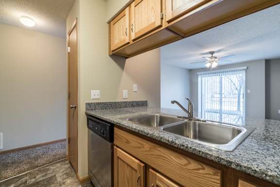 A kitchen with granite countertops and stainless steel appliances.