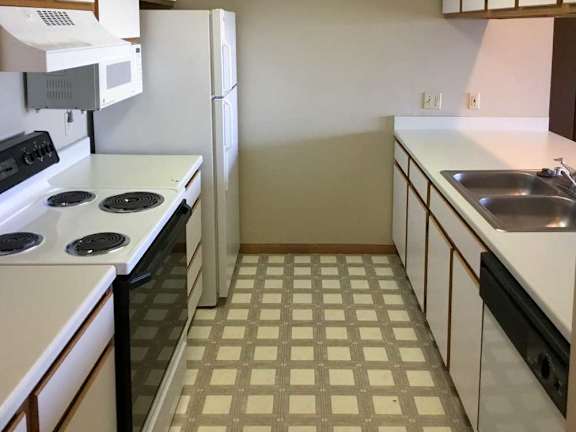 a kitchen with white appliances and white and brown cabients
