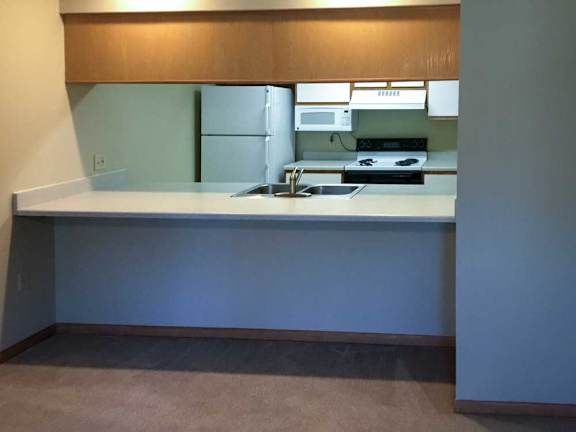 a kitchen with a windowed countertop for dining seating