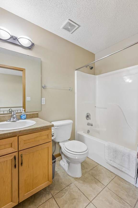 A bathroom with a white toilet, sink, and bathtub.