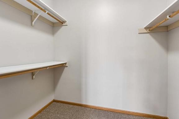 Spacious walk-in closet featuring shelving and hanging space.
