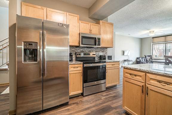 Upgraded unit with side-by-side stainless steel fridge and appliances at Southwind Villas townhomes in La Vista, NE, 68128
