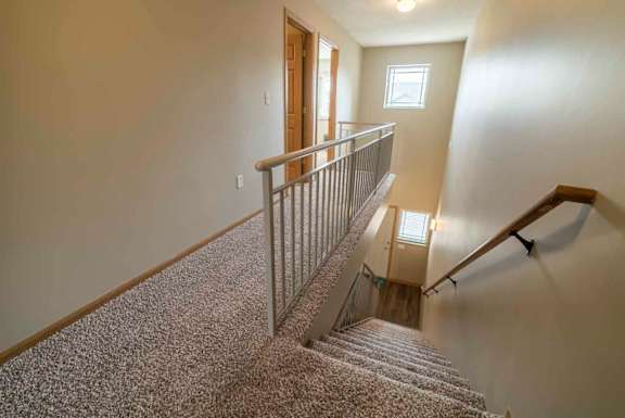 Stairwell to upstairs in a two-bedroom townhome at Southwind Villas in southwest Omaha in La Vista, NE, 68128