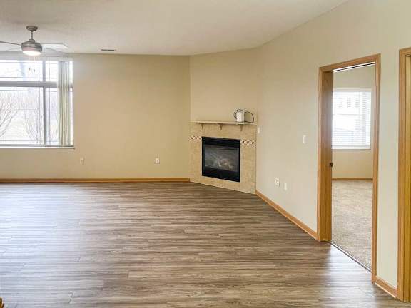a living room with a fireplace and luxury vinyl hardwood flooring
