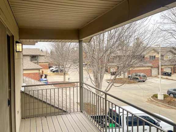 a view from a balcony overlooking a parking lot and other villas