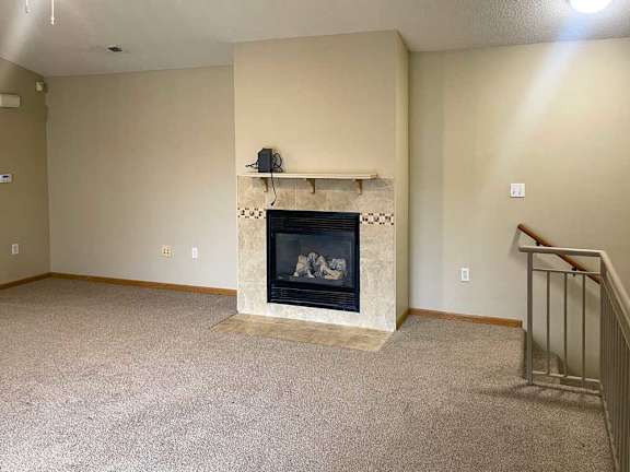 a living room with a fireplace and a mantle