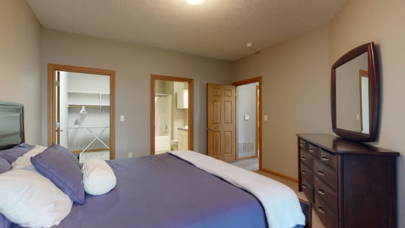a master bedroom with walk in closet and private bath