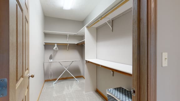 a walk in closet with ample hanging and shelving space
