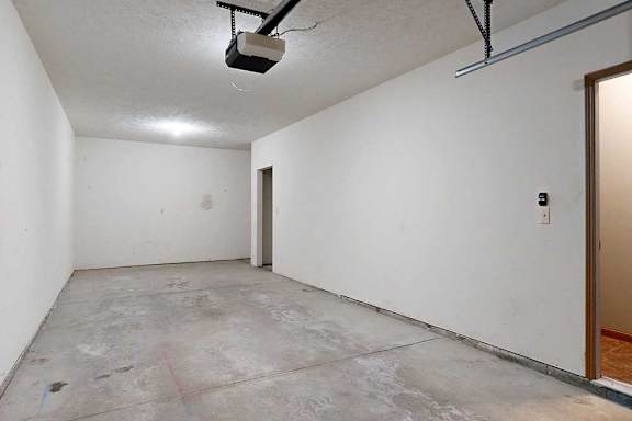 A tandem 2-car garage with under-stair storage.