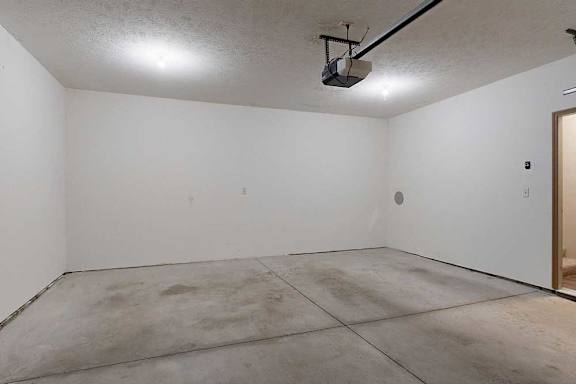 A 2-car attached garage with over head lights, and a door to the apartment.