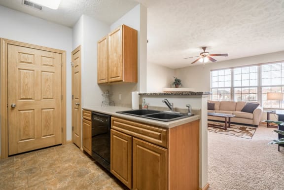 a view of a kitchen and a living room with a staircase
