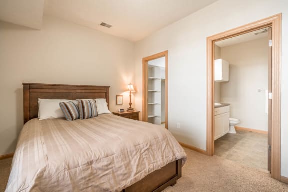 a bedroom with a bed and a bathroom with a toilet