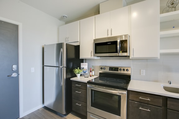 a kitchen with stainless steel appliances and white cabinets