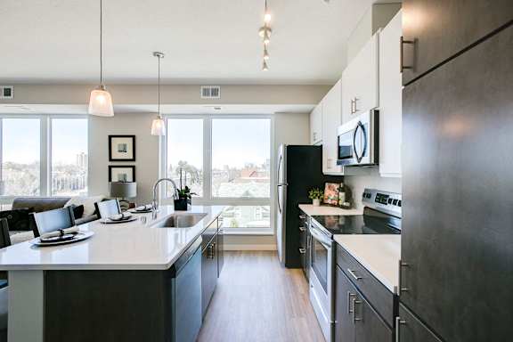 Kitchen with island and pendant lighting at The Central apartments near downtown Minneapolis MN 55408