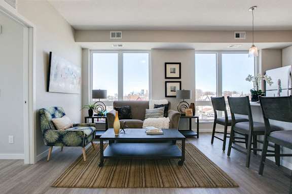 Living room with view of downtown through large windows at The Central apartments near downtown Minneapolis MN 55408