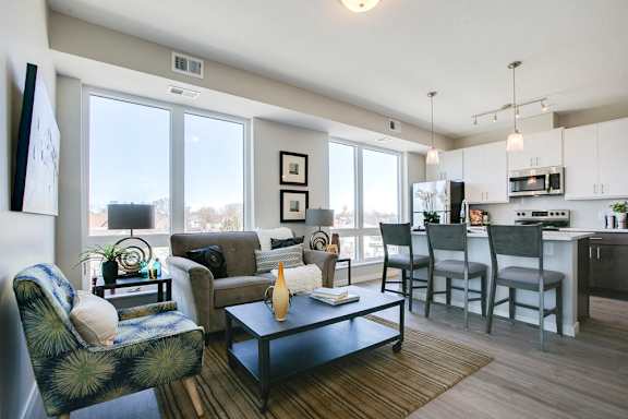 Open floor plan with white cabinetry and hardwood-style floors at The Central apartments near downtown Minneapolis MN 55408