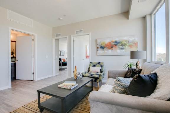 Living room with view of bathroom and bedrooms at The Central apartments near downtown Minneapolis MN 55408