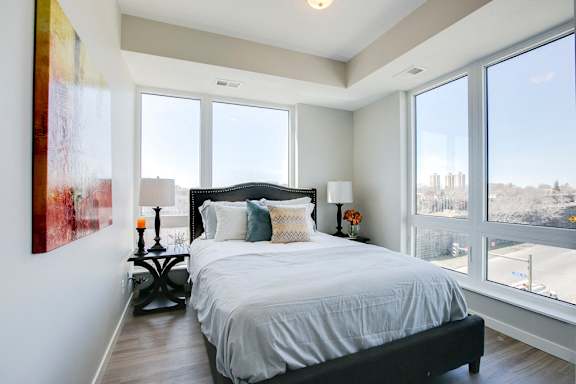 Bedroom with large windows and high ceilings at The Central apartments near downtown Minneapolis MN 55408