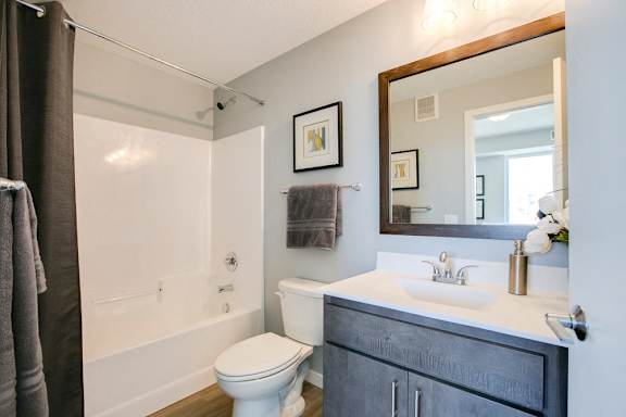 Bathroom with tub and quartz countertops at The Central apartments near downtown Minneapolis MN 55408
