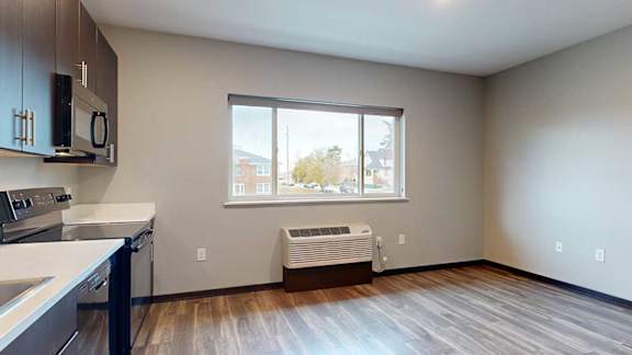 a kitchen and living room with a large window