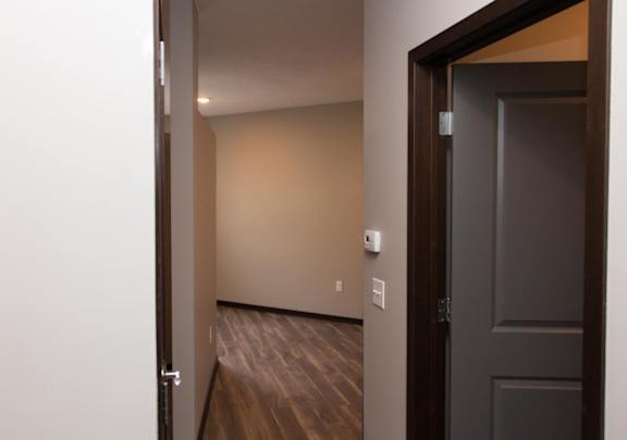Entryway of studio apartment with bathroom door to the right