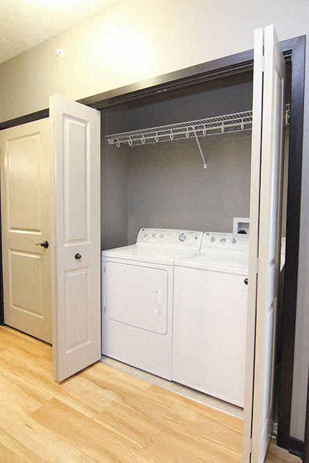 A white washer and dryer in a small laundry room.