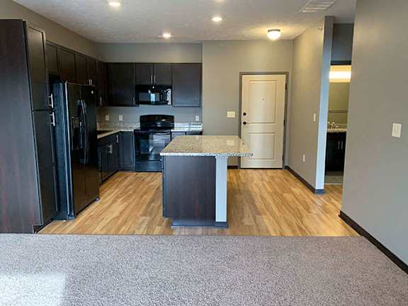 Spacious kitchen with a large island with light granite counter tops  of 1 bedroom apartment for rent at The Flats at 84 best   apartments Lincoln NE 68516